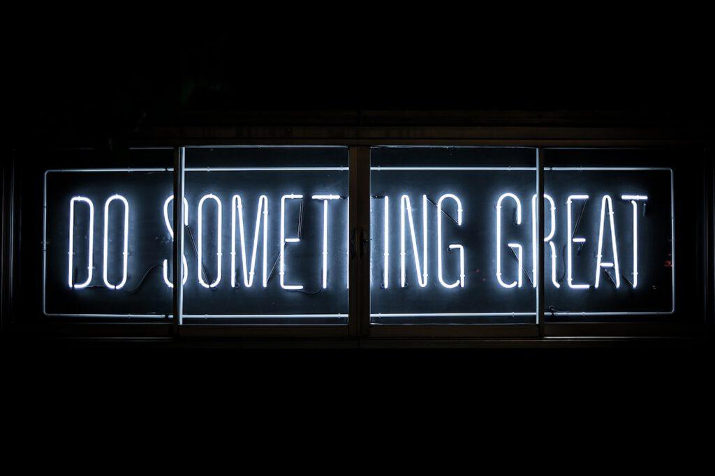 white neon sign that says Do Something Great