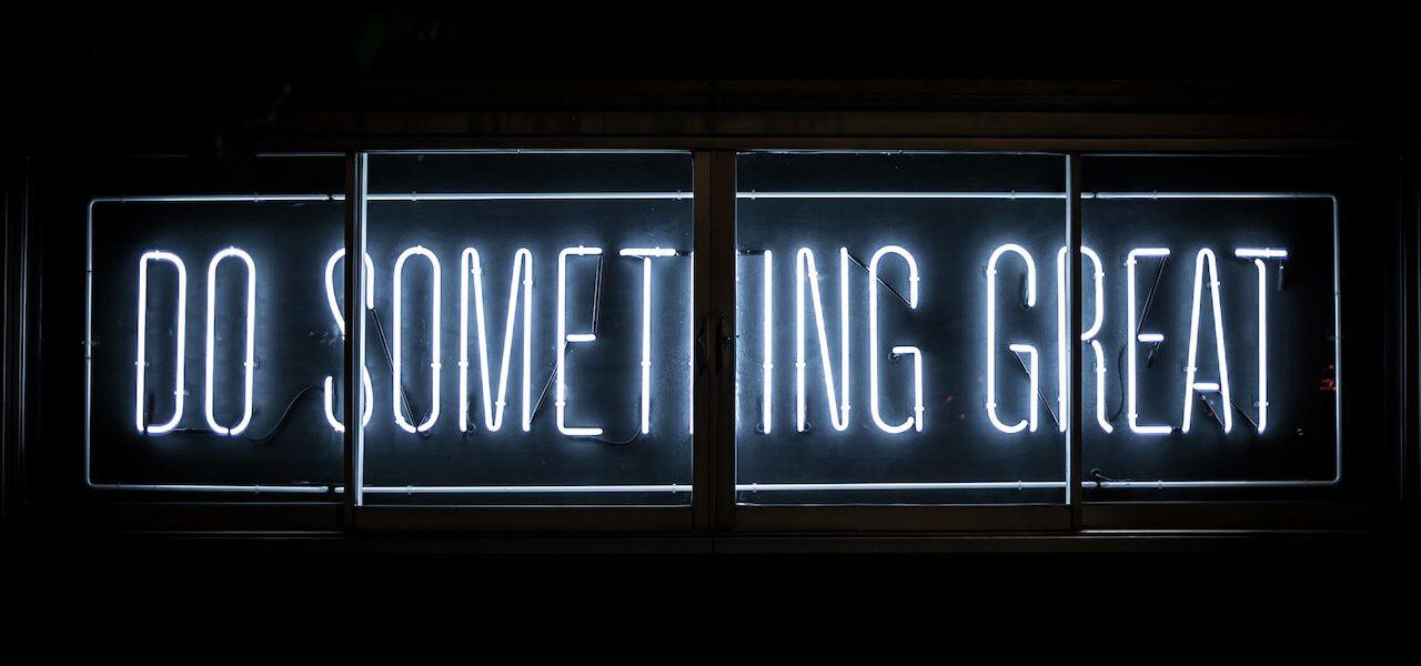 white neon sign that says Do Something Great