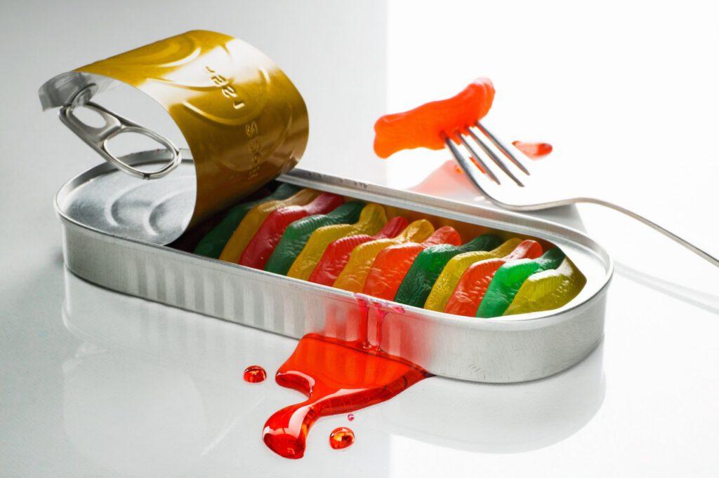 open tin of colourful gummy fish