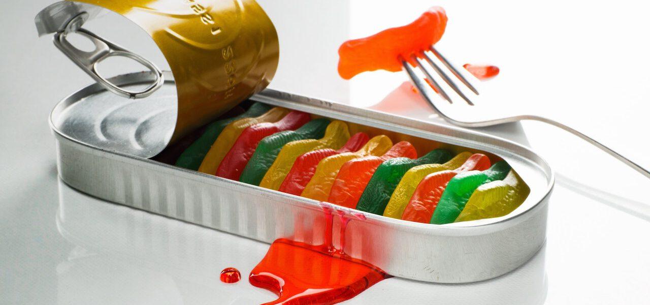 open tin of colourful gummy fish