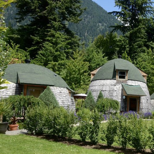 two grey and green domes in a mountain garden