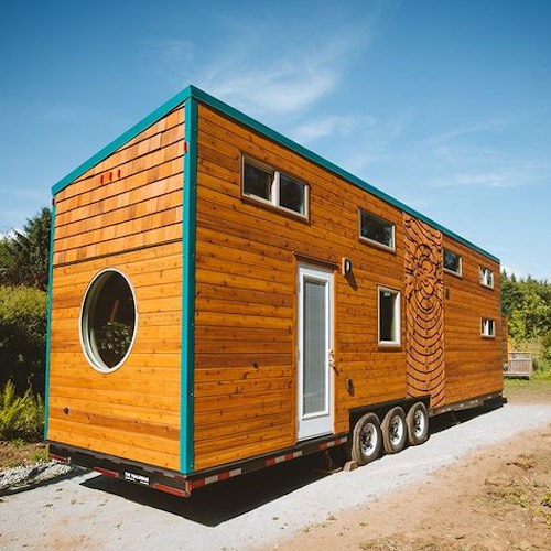 large wood-sided Sunshine tiny house on wheels