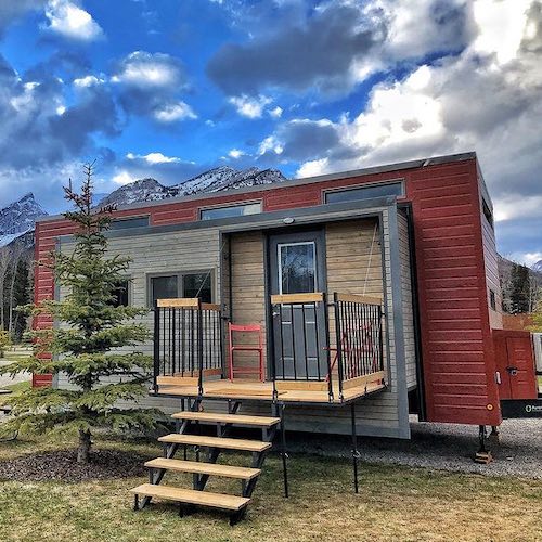 Medium ZeroSquared tiny house on wheels with pullouts in mountain parking spot
