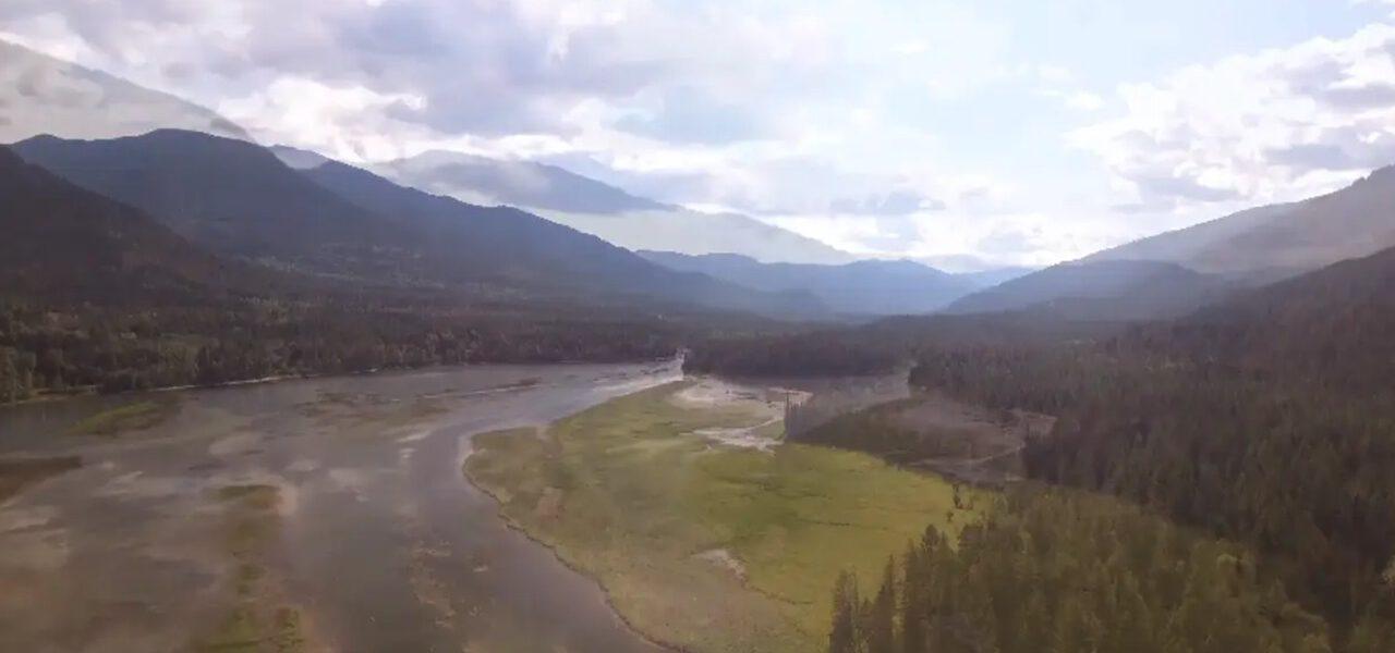 aerial view of a lush valley with river