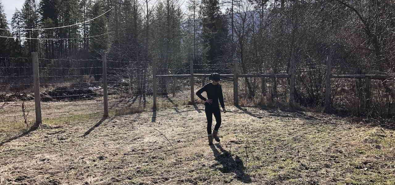 Woman in an unplanted garden at springtime