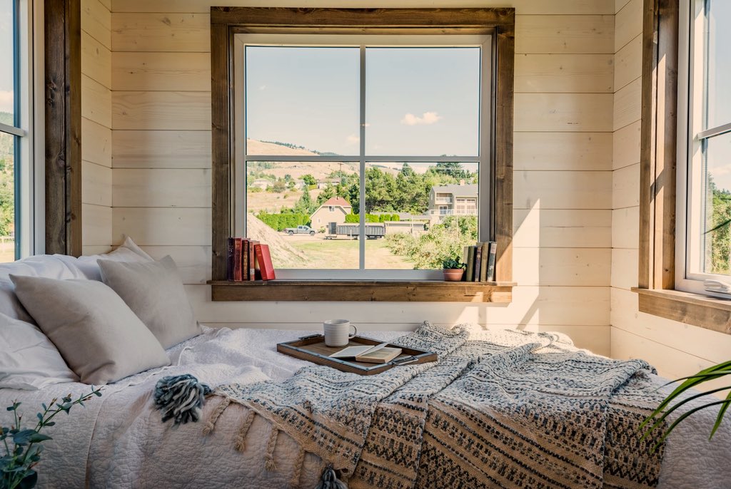 tiny house bedroom with farm outside window