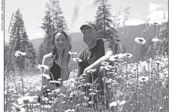 Black and white photo of a couple in a field of flowers